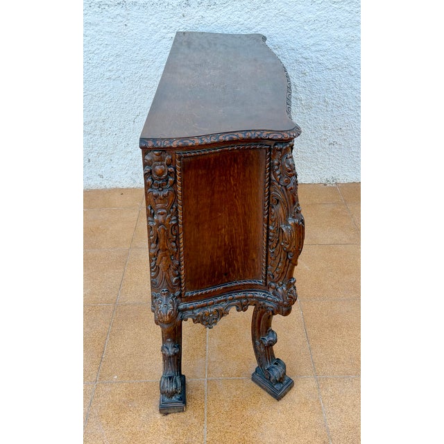 Impressive Spanish commode crafted in wood, featuring an extensively carved and richly ornamented design inspired by the...