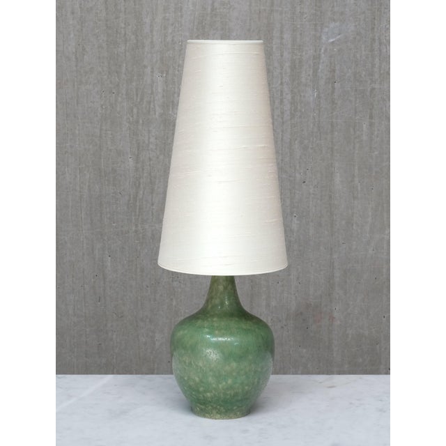 This rare table lamp was designed by carl-harry stålhane and produced by rörstrand in sweden in the 1950s. The piece is...