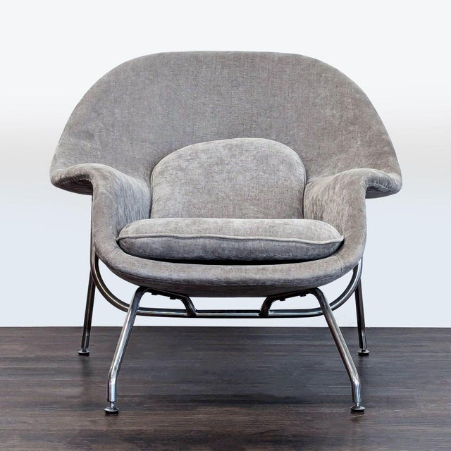 This lounge chair features a soft gray fabric, plush seat and back cushions, and sturdy metal legs. Its wide, curved back...