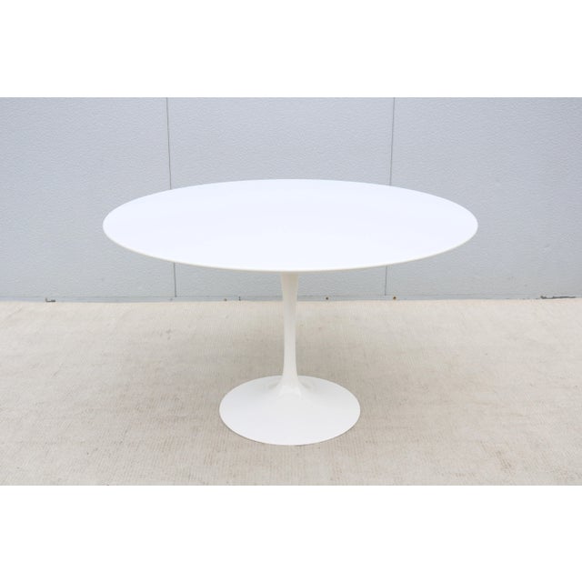 Fabulous 47" round white laminate top dining table designed by Eero Saarinen for Knoll. It was introduced in 1956 and...