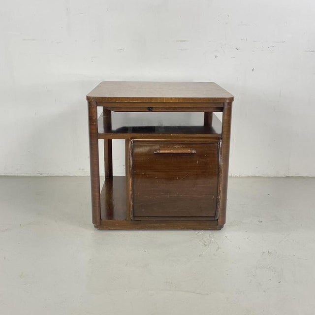 Lovely 1930s Art Deco walnut cabinet by Incorporall. Wonderful flip door action with bottle and record compartment. In...