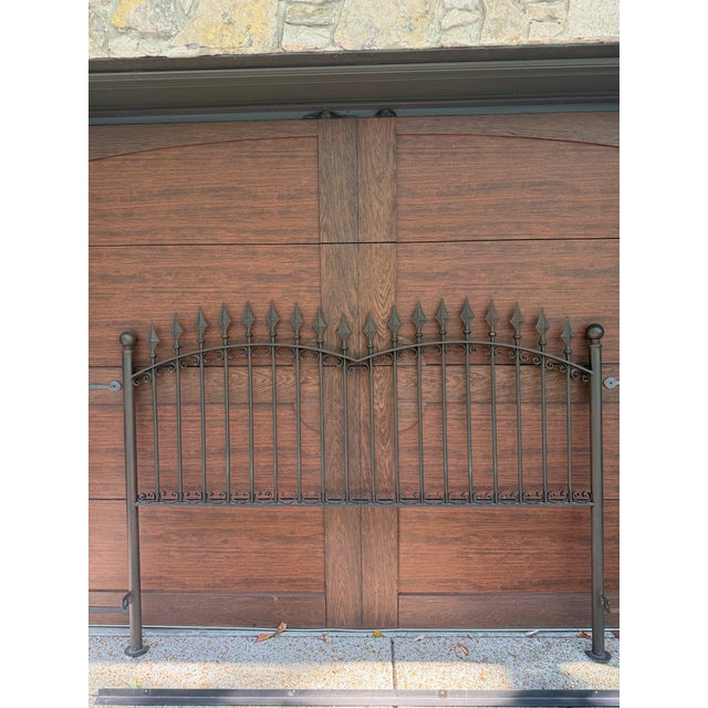 Beautiful wrought iron headboard constructed from a property gate by Herndon and Mary. The headboard features scrolling...