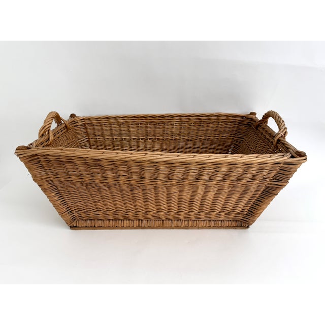 Traditional 1960s woven wicker French market basket with braided handles Two wood supports on the bottom extend the length...