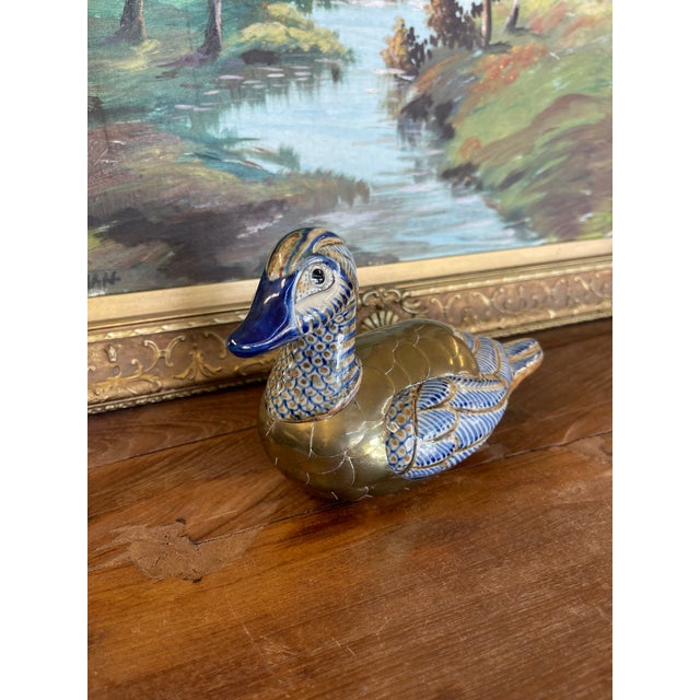 A vintage Chinese cloisonné and ceramic duck figurine, crafted with a combination of hand-painted ceramic and applied...
