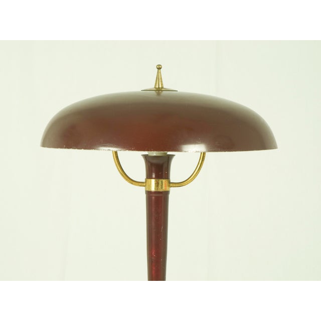 This table lamp was produced in Italy around the 1950s. It is made from painted metal, cast iron and brass. It remains in...