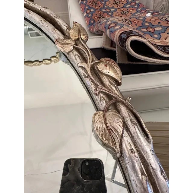 This is a vintage mirror with a vine and leaf detail throughout. Oval in shape this mirror has just the right amount of...