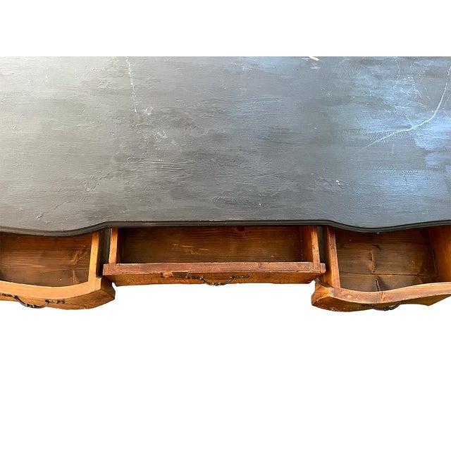 This piece features three large drawers and beautiful cabriole legs. The top is painted black.