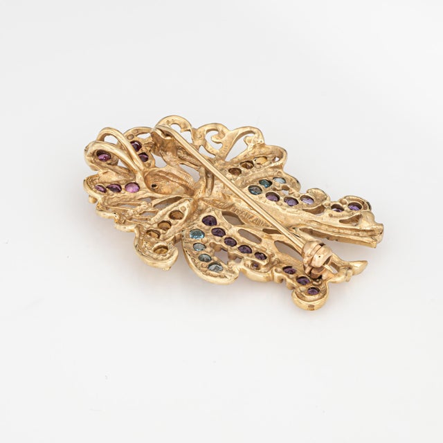 Stylish and finely detailed Las Vegas Showgirl pendant crafted in 10 karat yellow gold (circa 1970s to 1980s). Amethyst,...