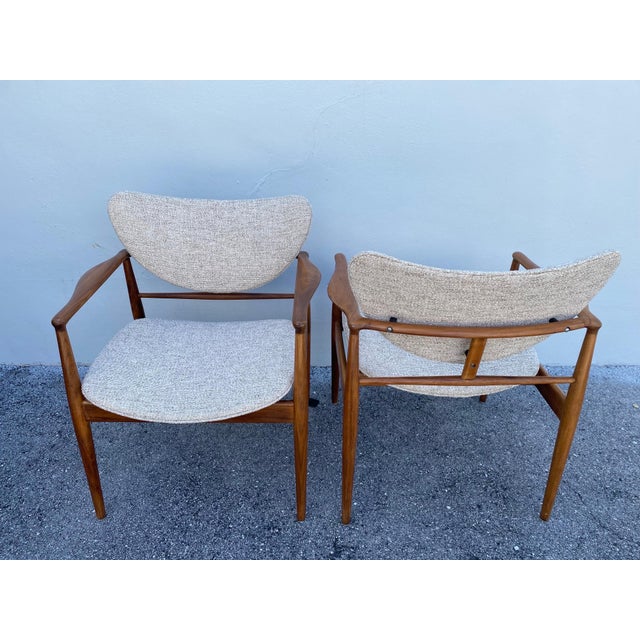 These are a pair of Finn Juhl's 1950's iconic No. 48 open armchairs manufactured by Baker USA - all original with new...