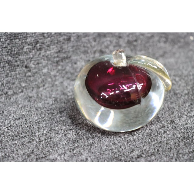 Deep red art glass apple paper weight with gold leaf.