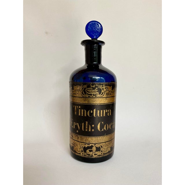 Rare late 19th-century apothecary bottle in deep cobalt blue glass, retaining its matching ground glass stopper and...