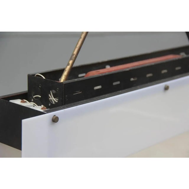 This Italian pendant is of minimalist and modern design, made with Acrylic Glass, brass, glass, and lacquered metal...