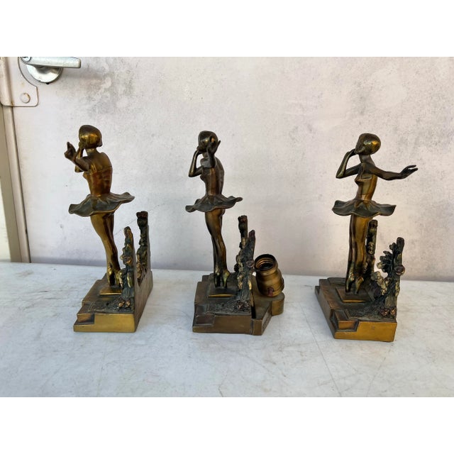 Heavy solid bronze statue of a ballerina. The 3 pieces matching are 2 bookends and 1 is a light. All about 10.5” tall. The...