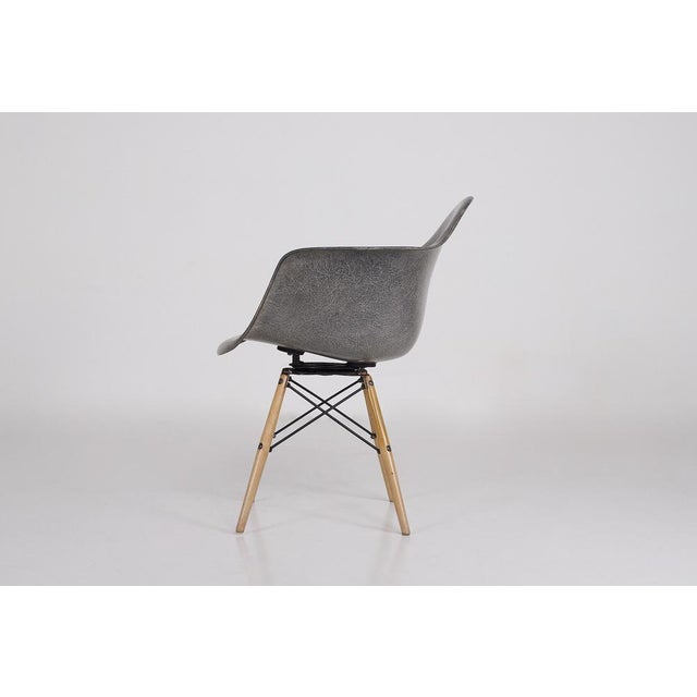 Paw (pivot armchair wood base) chair in gray fiberglass, designed by charles & ray eames for herman miller. First...