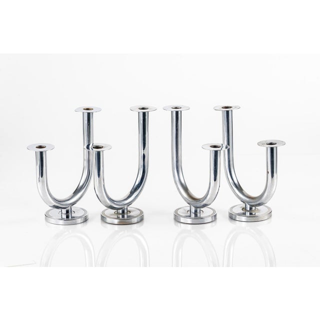 Set of four "Taurex" candlestick holders by German designer Walter Von Nessen (1889-1943) for the Chase Brass & Copper...