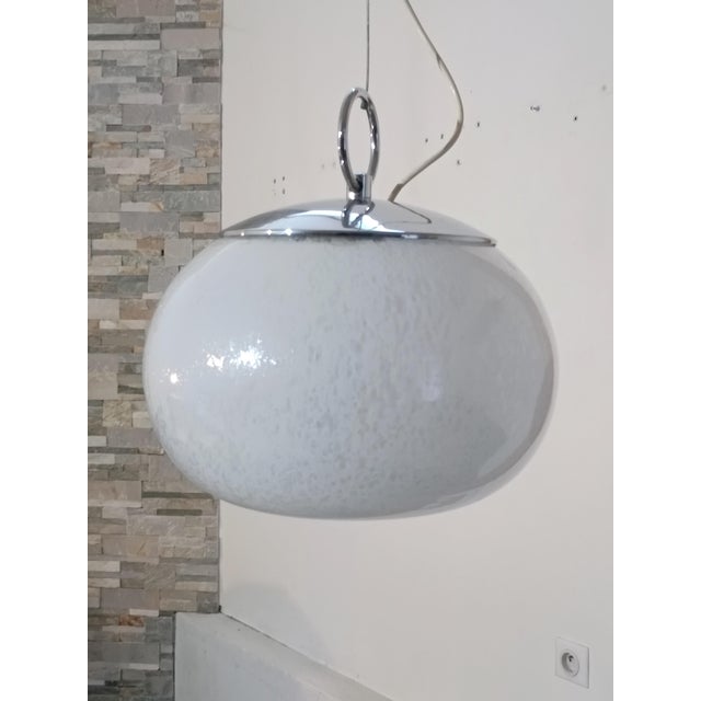 Beautiful pendant lamp by Mazzega. Italy, 1970s. Chrome-plated metal frame. It supports a large frosted, hand-blown Murano...
