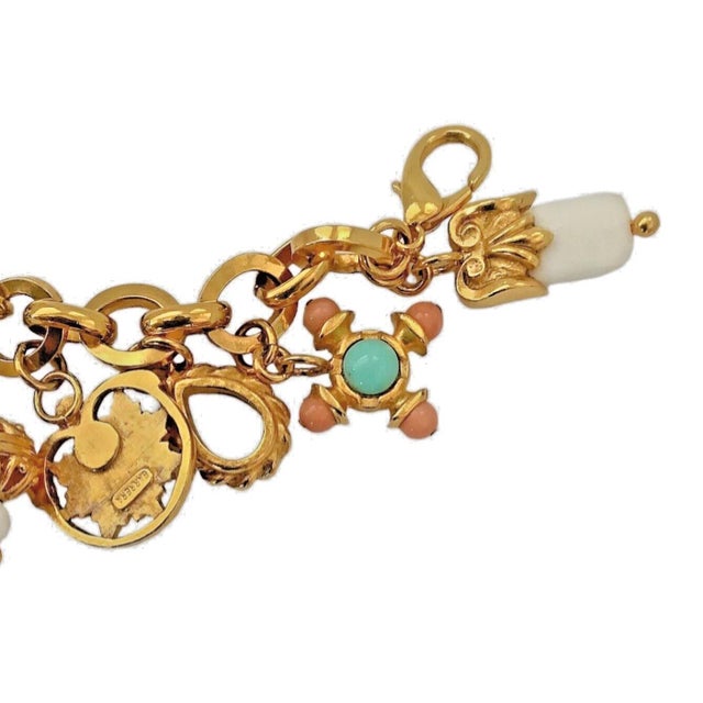 This charms bracelet is designed and crafted by JOSÉ & MARIA BARRERA 22K Gold Plate. High polish and texture Charms...