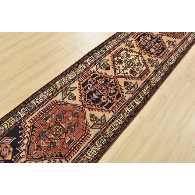 An authentic vintage tribal Sarab runner hand-knotted with fine wool and natural dyes. This nomadic rug features geometric...