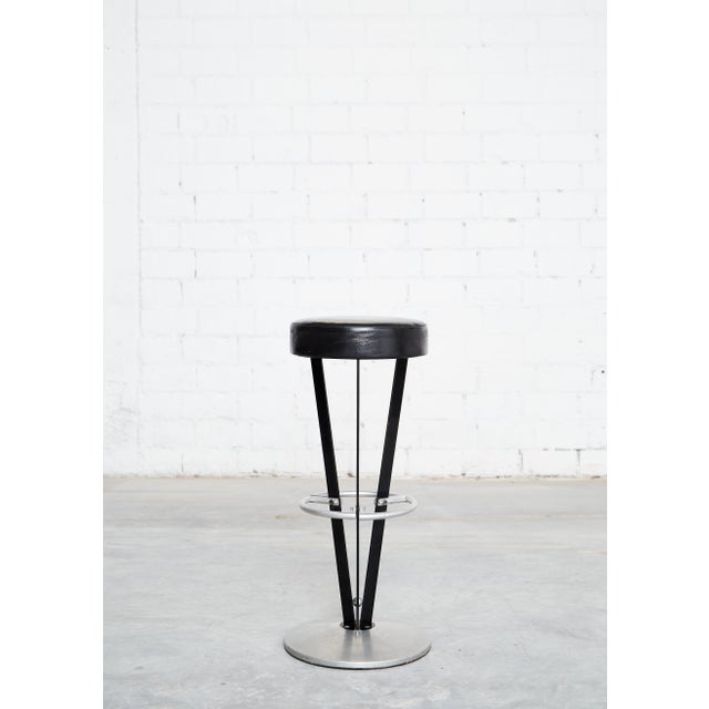The set consists of four stools. Condition: Metal frame, seats upholstered in black leather. Good used condition with age-...
