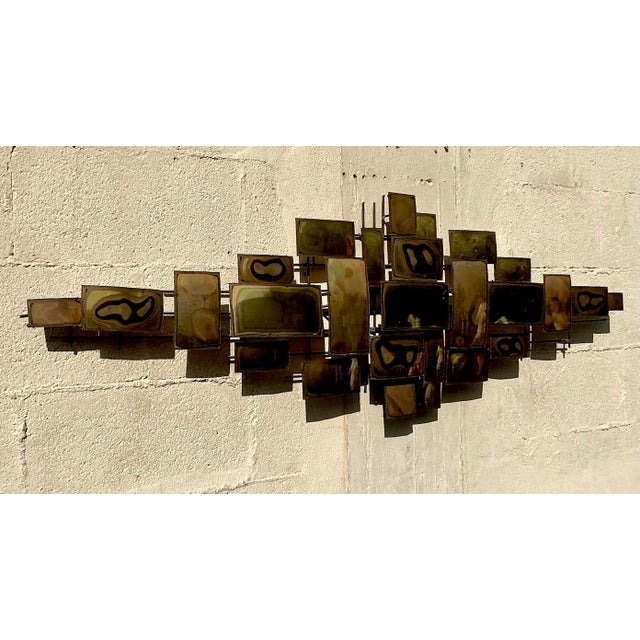This vintage wall sculpture showcases stunning torch-cut metal artistry with bold textures and organic shapes. Renowned...
