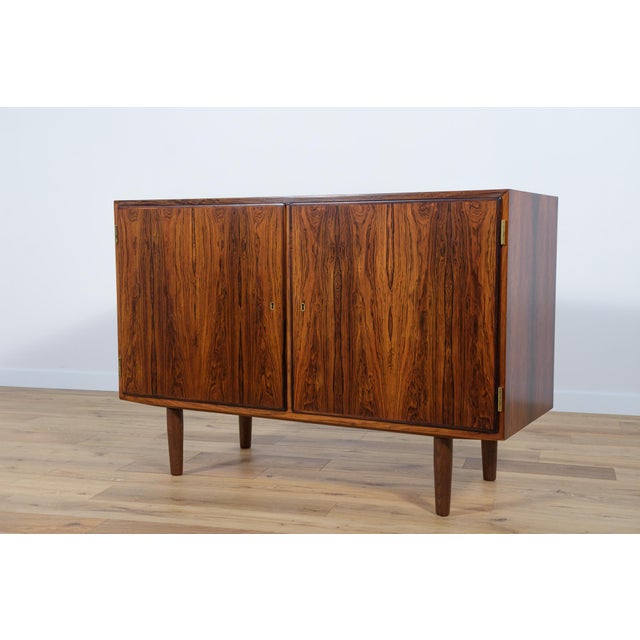 This is a small sideboard designed by Poul Hundevad in the 1960s. It was manufactured by the Hundevad & Co furniture...