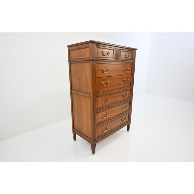 A refined Kindel Grand Rapids cherry chest of drawers, crafted in richly figured, warm-toned cherry wood with elegant...