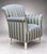 An upholstered lounge chair featuring rolled arms, a high curved back, and tapering wooden legs. The piece is covered in a...