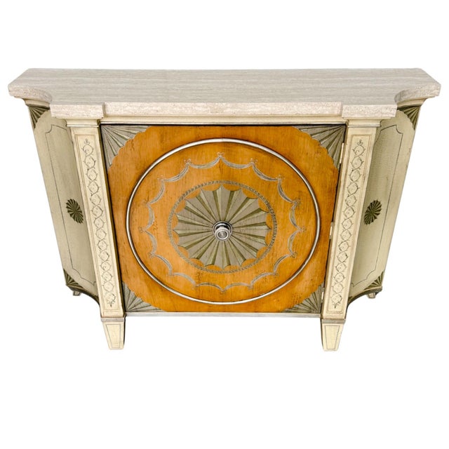 A vintage Neoclassical style console cabinet / commode featuring a dramatic serpentine silhouette with recessed side...