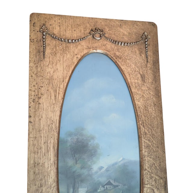 Gorgeous antique landscape painting in ornate wood frame featuring ornamental swags and festoons. Circa early 1900s, the...
