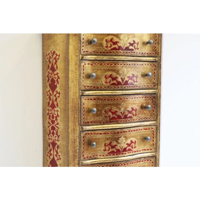 Gorgeous Italian Florentine style tall chest of six drawers. Gorgeous gold wood with painted red accents. The curved...