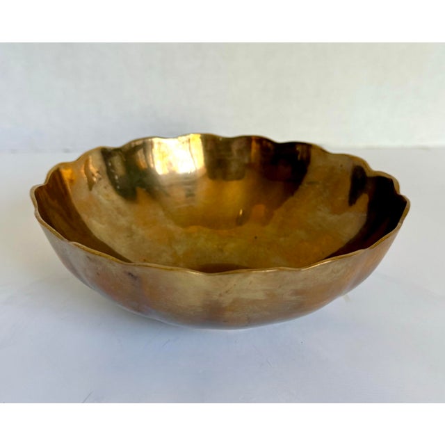 Here is a charming vintage brass finger bowl dating to the mid-20th century. Beautifully shaped with a softly scalloped...