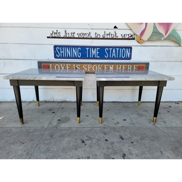 Vintage set of two mid-century modern black wood base with brass tip and gray marble top side tables. Marbles just sit on...