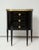 Pair of ebonized French marble-top petite commodes with brass gallery and pull-out drawers.