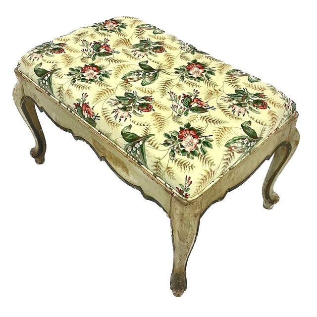 Antique Italian tufted floral upholstered footstool. Hand-painted wood frame with carved aprom and cabriole legs. Newly...