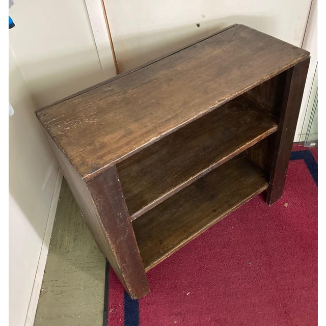 Three-tiered wooden shelf, likely a bucket bench or crock shelf. These types of shelves were historically used for storing...