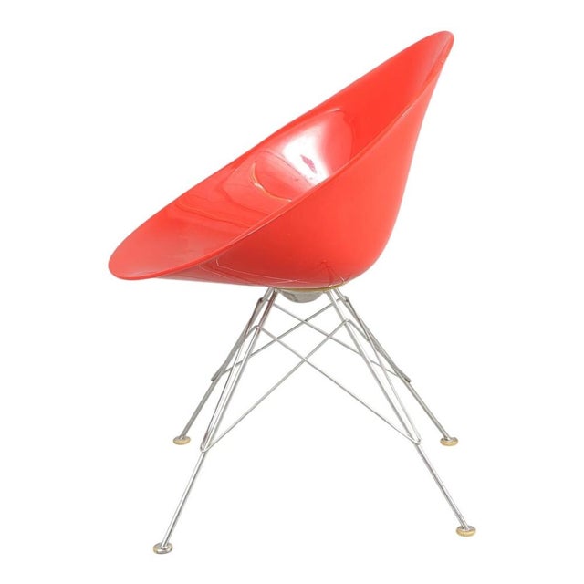 A set of four “eros” chairs with frames made of chrome-plated steel and shells of red plastic. Manufactured at karttell...