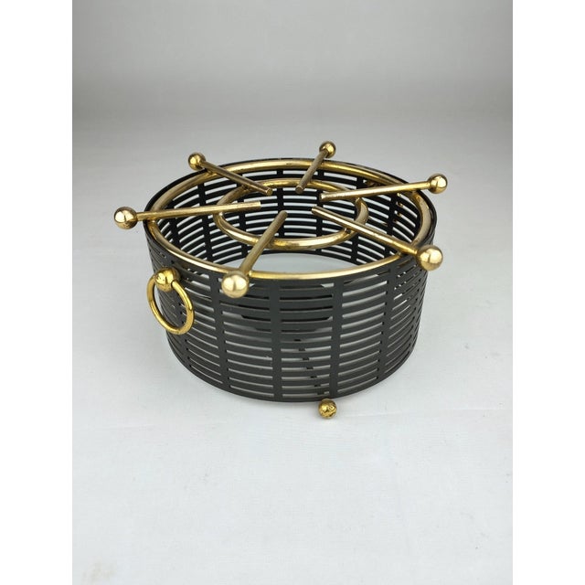 A rare, high-quality tea warmer that reflects the modern elegance of its era through the contrast of black perforated...