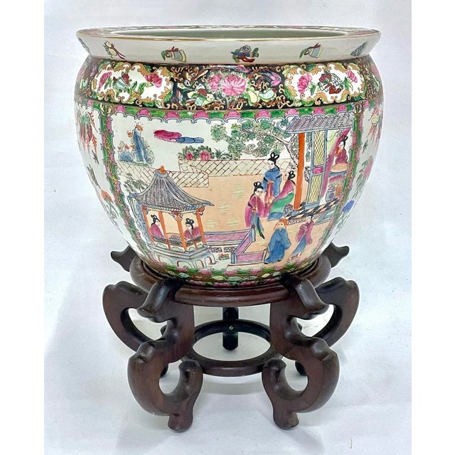 Vintage porcelain Chinese floral and scenic fishbowl with stand. Depicts multiple Asian themed scenes of birds and figures...