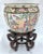 Vintage porcelain Chinese floral and scenic fishbowl with stand. Depicts multiple Asian themed scenes of birds and figures...