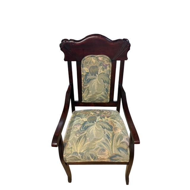 Elegant mahogany-finished armchair featuring a shaped crest rail with carved fan and scroll motifs inspired by late...