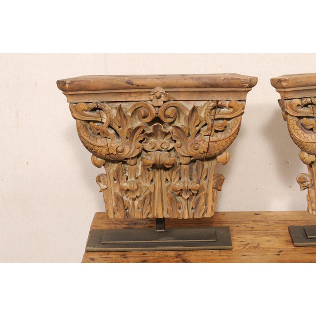 An Italian pair of nicely displayed carved-wood architectural fragments from the early 20th century. This pair of antique...