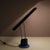 A modern, adjustable desk lamp made in Italy around 1980. Made of high quality black lacquered metal with tubular blue...