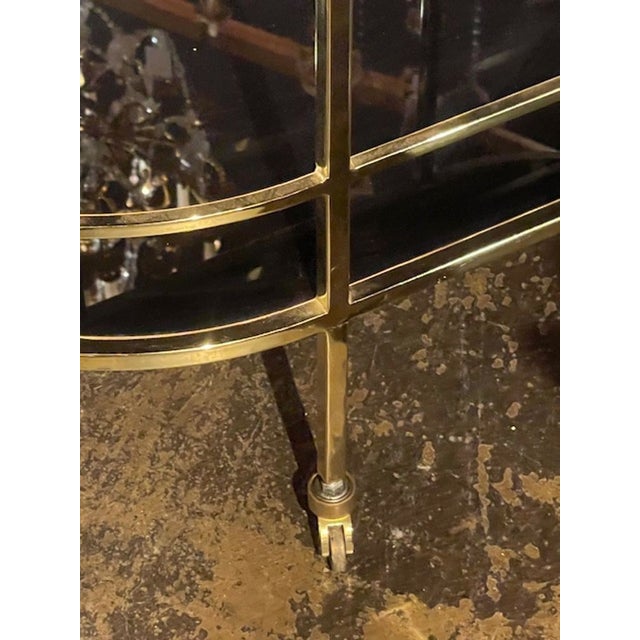 The MCM German Brass and Glass Bar Cart is a stylish and functional addition to any home bar or entertaining space. With...