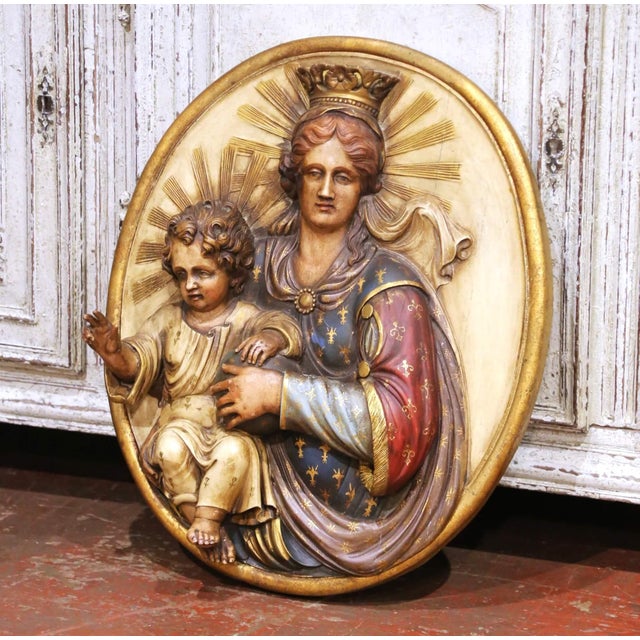 This striking antique religious wall plaque was crafted in Spain circa 1870 and depicts the Madonna and Child in high...