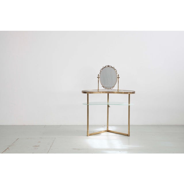 1950s dressing table, attributed to Luigi Brusotti. Features a tilting mirror, a main glass shelf, and a lower, frosted...