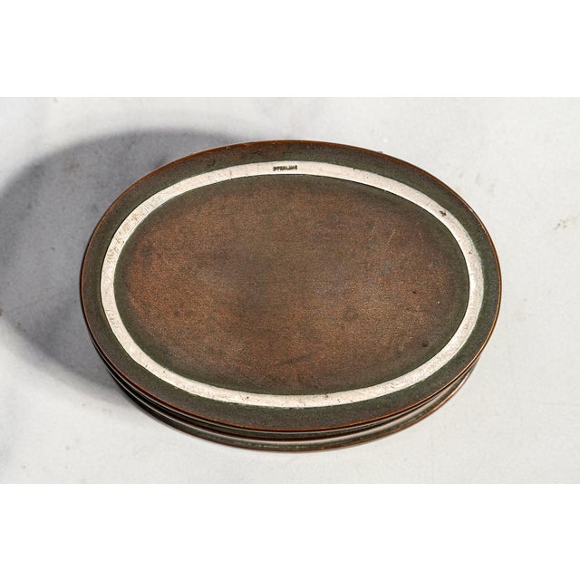 A wonderful example of early 20th-century American Arts and Crafts design, this antique Heintz Art Metal Shop stamp box...