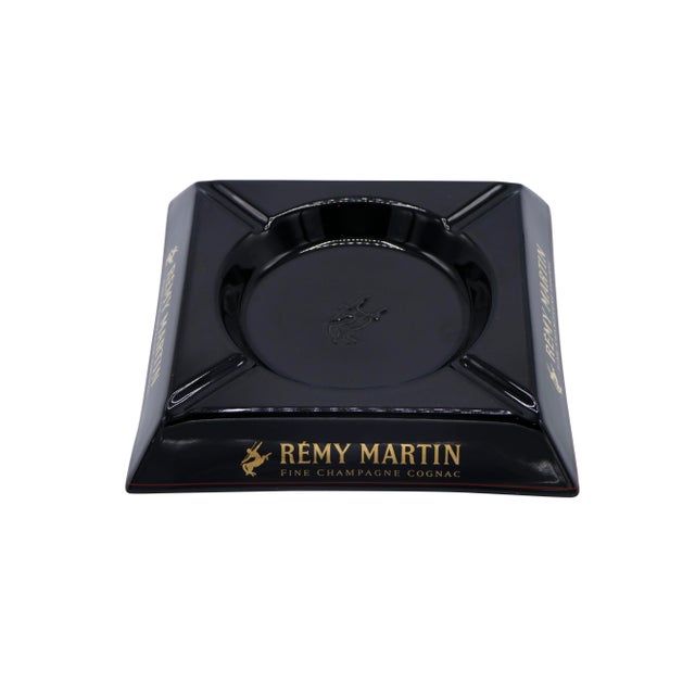 A French black square ceramic ashtray made by Rémy Martin. A central circular tray is embossed with the Rémy Martin logo,...