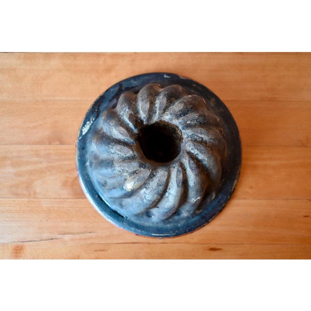 Glazed terracotta kougelhopf mold, an early 20th-century Alsatian ceramic product. Used extensively in a bakery or in a...