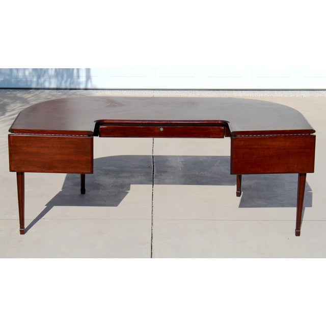 A beautifully crafted mid-20th century Georgian Revival hunt table/executive desk by Myrtle Desk Co. of High Point, North...