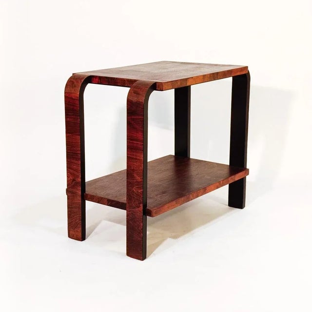 Sculptural Italian Art Deco side table in the style of Osvaldo Borsani, 1930s. Made of walnut wood, this piece is made up...